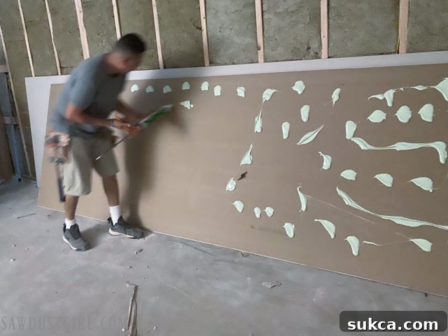 Lodge Drywall Installation Update 5 6 Drywall sheet with Green Glue applied before second layer