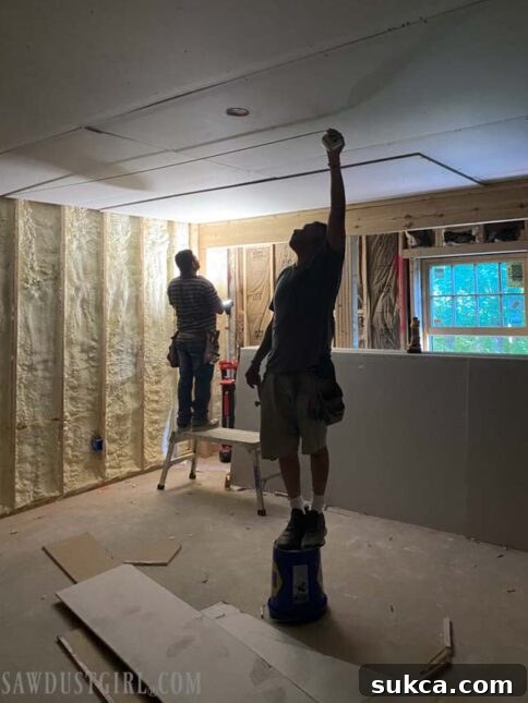 Lodge Drywall Installation Update 5 7 Drywall hangers installing the second layer of drywall with Green Glue