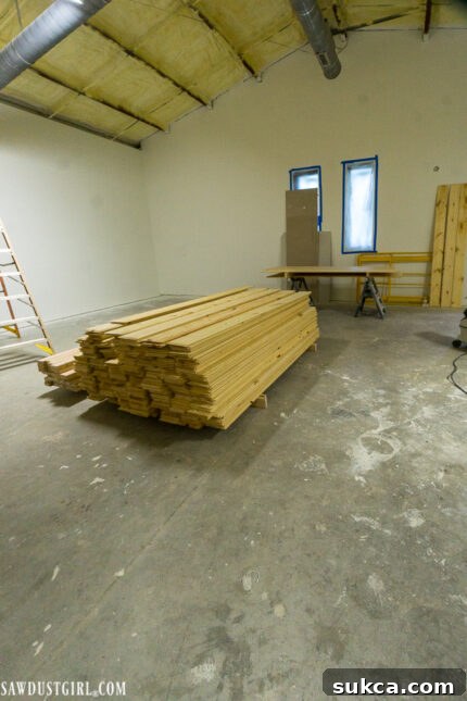 Freshly cut pine planks awaiting a Scandinavian whitewash finish for a lodge ceiling