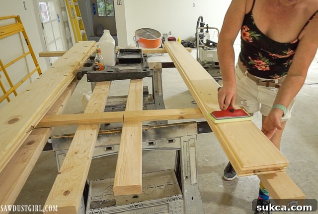 Applying Bona NordicSeal with a paint pad to pine wood planks