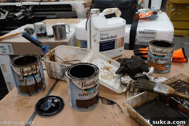 Assortment of water-based wood stains laid out for mixing and application.