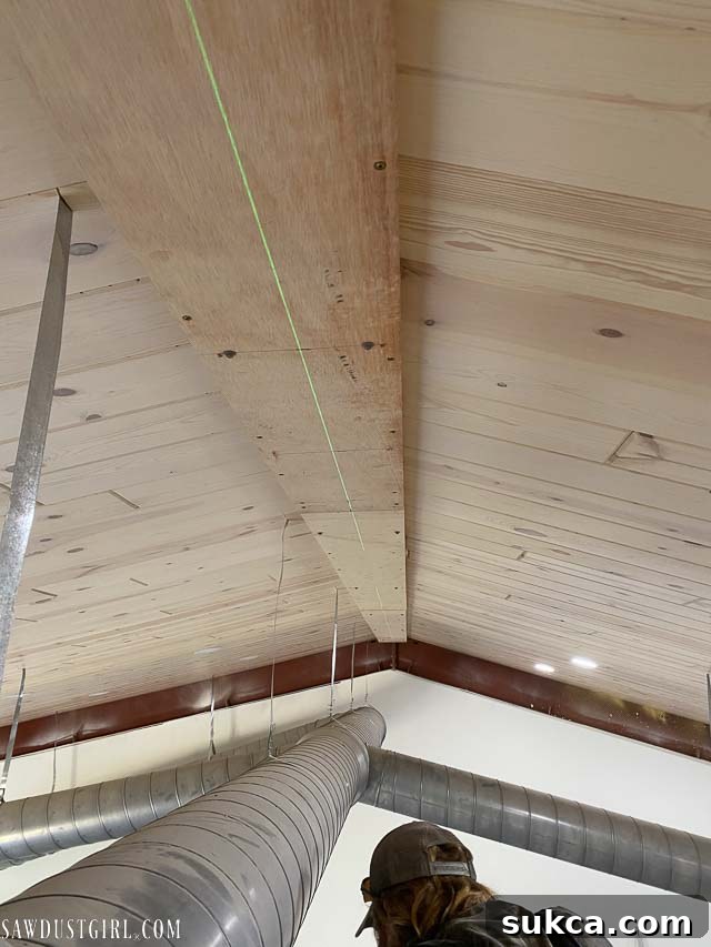 Connecting a subsequent nailer plate section, aligning plywood to the extended 2x2s.