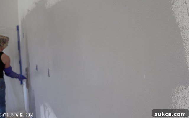 Applying concrete overlay to a wall with a trowel
