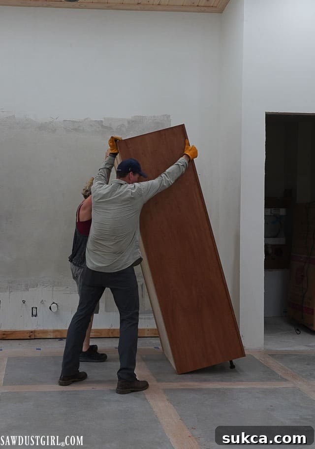 Oven cabinet positioned against the kitchen wall