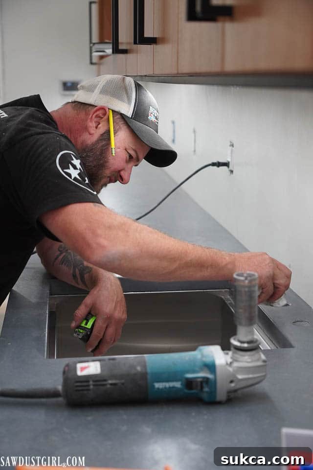Close-up of a new sink integrated into the concrete countertop, showing the seamless installation.