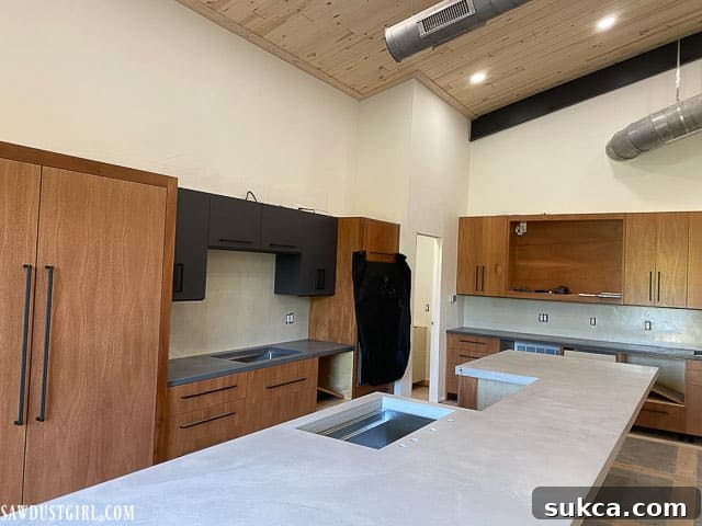 View of the kitchen sink area with concrete countertops and newly installed faucet holes.