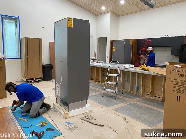 Refrigeration columns being installed into custom cabinetry in the Lodge kitchen.