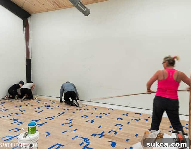 Close-up of engineered wood flooring installation, showing planks being carefully aligned and secured.
