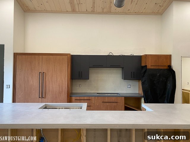 Kitchen cabinets in progress, showing the initial height and consideration for lighting installation.