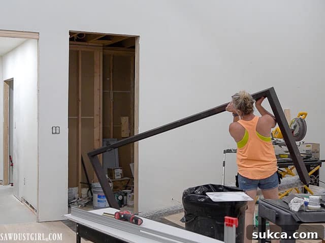Heavy iron door frame being positioned, showing the challenges of installing oversized architectural elements.