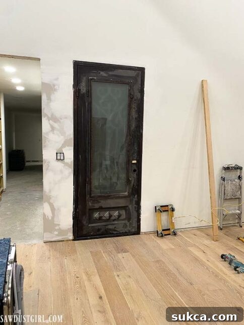 The installed heavy iron door, showing the side facing the living room, revealing an unexpected aesthetic.