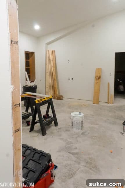 The bedroom space designated for renovation tools, with some structural work visible.
