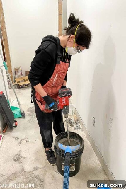 A closer view of the laundry room floor being leveled and prepped for new flooring.