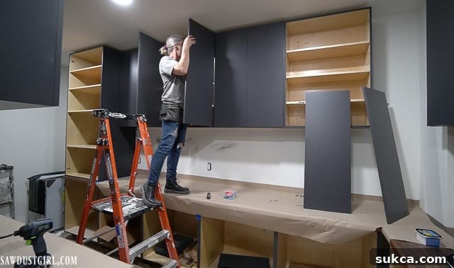 A partially finished custom pantry with built-in shelving, showcasing the intricate woodworking and planning involved.