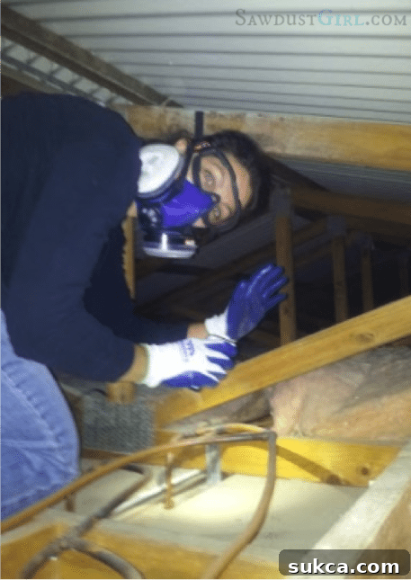 Navigating the Attic Space for Wiring Crawling through attic insulation to route wires