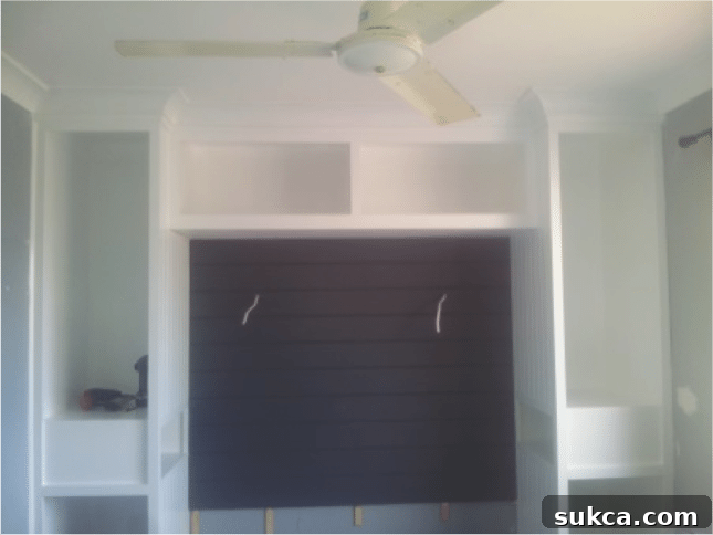 Initial Charcoal Wall Paneling for Built-ins Dark wall paneling making small bedroom look smaller
