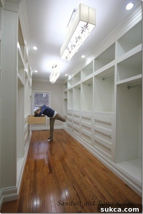 White built-in master closet showcasing custom cabinetry and spacious design
