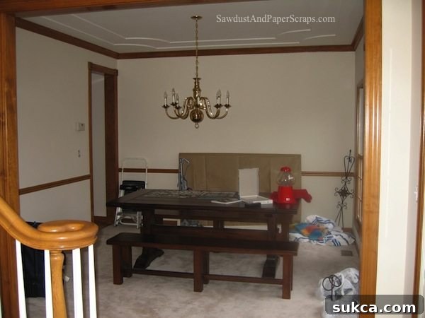 Dated dining room in Illinois house before renovation, featuring old paint and fixtures