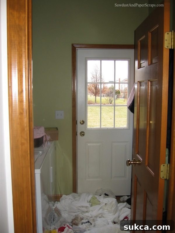 Illinois laundry room before renovation, showing cramped space and outdated appliances