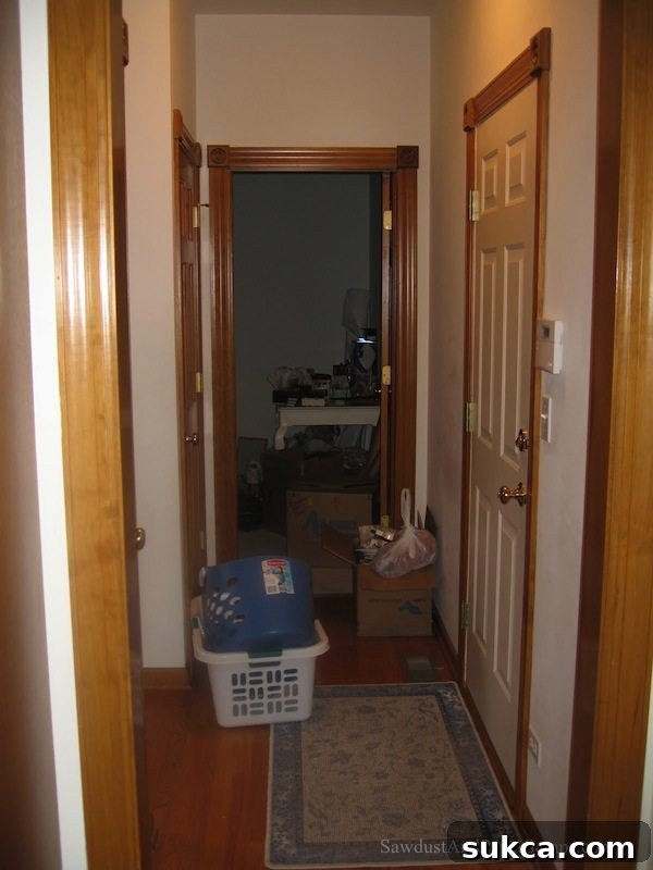 Long hallway in Illinois house before renovation, connecting garage, laundry, and office
