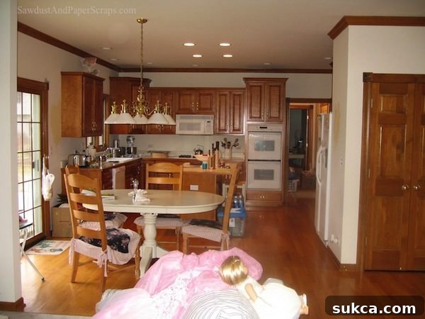 Old kitchen in Illinois house before complete renovation, featuring dated cabinets and appliances