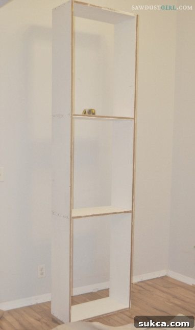 Finished base cabinet for built-in library shelving, awaiting further assembly and installation