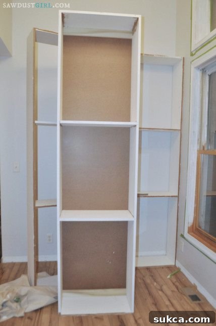 Building custom built-in bookshelves for a home library, carefully squaring each unit