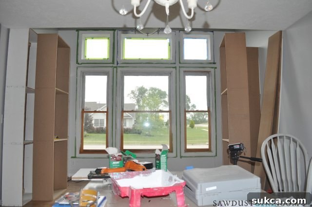 Overview of multiple built-in cabinet bookcases assembled in a room, ready for installation and finishing touches