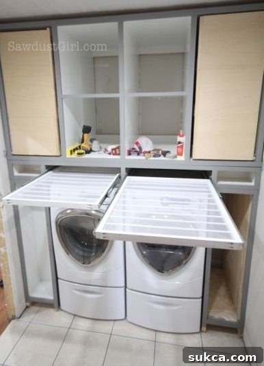 The pull-out drying rack smoothly gliding out of its hidden compartment.